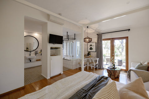 Modern bedroom with a view of a bathroom and living room.
