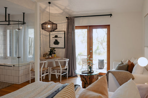 Living room with a couch, coffee table, and a view of a dining area.