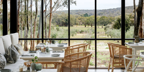 Modern interior with large windows offering a view of a scenic landscape.