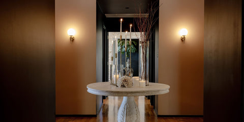 Round marble table with decorative items in a spa corridor